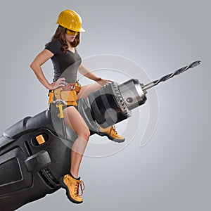 Worker girl sitting on a drill