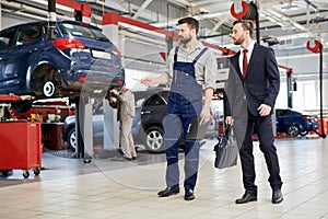 Worker Giving Tour of Car Factory