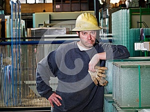 Worker in glass warehouse