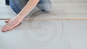 Worker glues extruded polyester with adhesive tape.