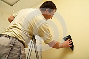 Worker glues new wallpaper