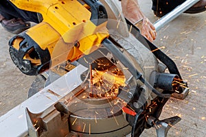 Worker grinding a metal plate