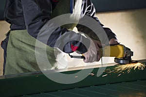 The worker grinding the steel mechanism on industry