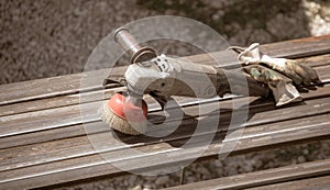 A worker grinds a rusty metal pipe