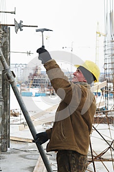 Worker with hammer assembling
