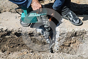 Worker hammer smashes the concrete