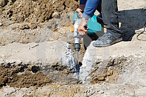 Worker hammer smashes the concrete