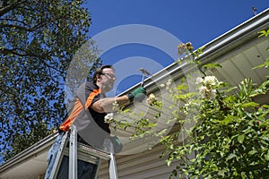 Worker Hammering Gutter Spike In