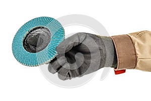 Worker hand in black protective glove and brown uniform holding blue abrasive flap disc for grinding isolated on white background