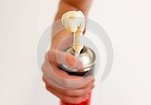 Worker hand holding polyurethane expanding foam glue gun applicator. Balon foam. Isolated on white background. photo