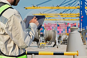 Worker hand holding tablet in port