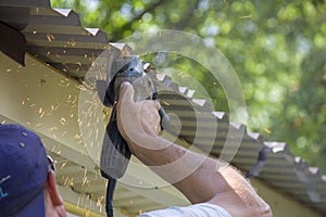 worker hand man holding broken grinder blade. Danger of using power tools. Close-up