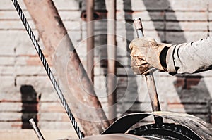 Worker hand pulling the lever of a pile driver