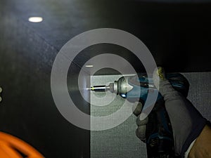 Worker hand screwing cabinet