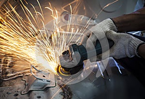 worker hand working by industry tool cutting steel with split fire use for industrial manufacturing theme