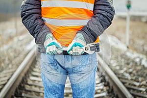 Worker hands with adjustable wrench on the railroad