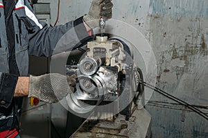 Worker hands close up, working with metal equipment in industrial factory