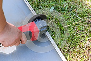 Worker hands cutting a metal sheet