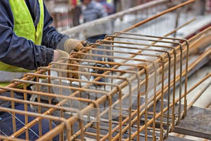 Worker hands fixing steel reinforcement bars