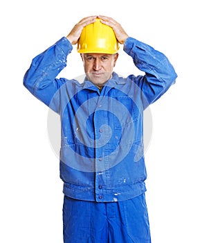 Worker with hands on his hardhat