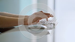 Worker hands holding mouse using wireless device at bright home office closeup.