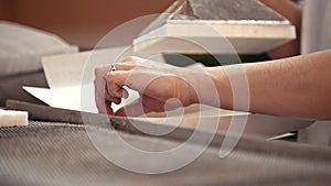 Worker hands puts white sugar from production line in the -box