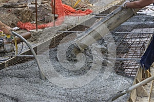Worker hands using concrete vibrator 2 photo