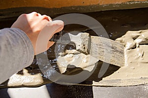 Worker hands using spatula and plastering ceiling with putty. Mesh on split. Closeup