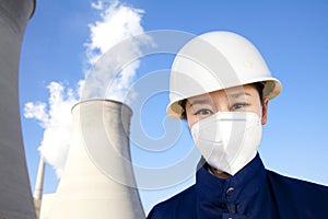 Worker with hardhat and mask at power plant