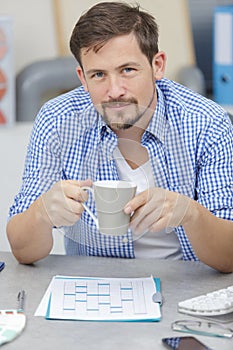 Worker having cup coffee