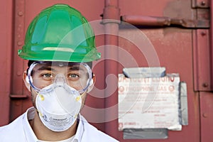 Worker in hazmat suit, hard-hat and face mask