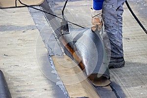 Worker heating and melting bitumen felt 2