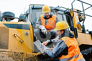 Worker with heavy excavation machinery in mining operation