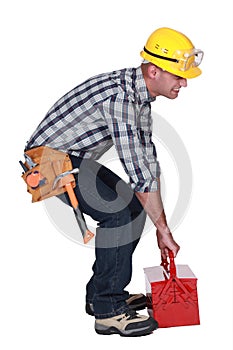 Worker with a heavy tool box