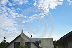 Worker in height on the top of the roof