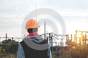 Worker in a helmet against the background of a substation