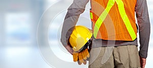 Worker with helmet in orange security vest.