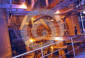 Worker on a high level gangway inside a power station.