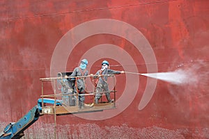 Worker on high wear safety harness on sherry picker car.