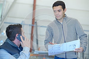 Worker holding design blueprint