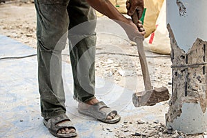 Worker holding hammer and smash to concrete pile