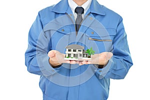 Worker holding a housing model