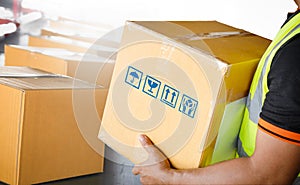 Worker Holding A Parcel Boxes. Package Boxes Sorting on Conveyor Belt. Distribution Warehouse Shipping. Supplies Shipment.