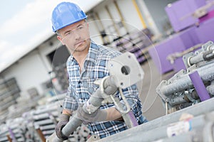 Worker holding scaffolding pole