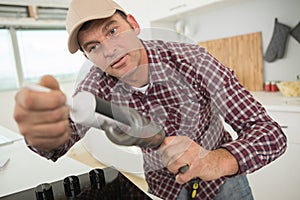 worker holding silicone sealant