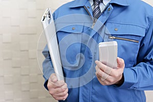 Worker holding a smart phone