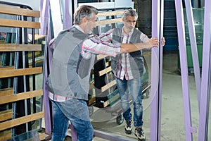 Worker holding wall mirror