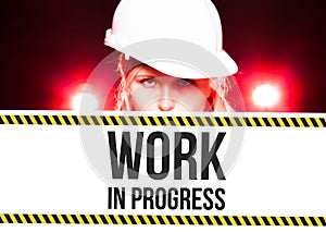 Worker holding work in progress sign on information board