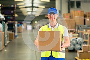 Worker holds package in warehouse of forwarding photo