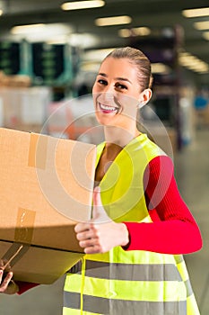 Worker holds package in warehouse of forwarding